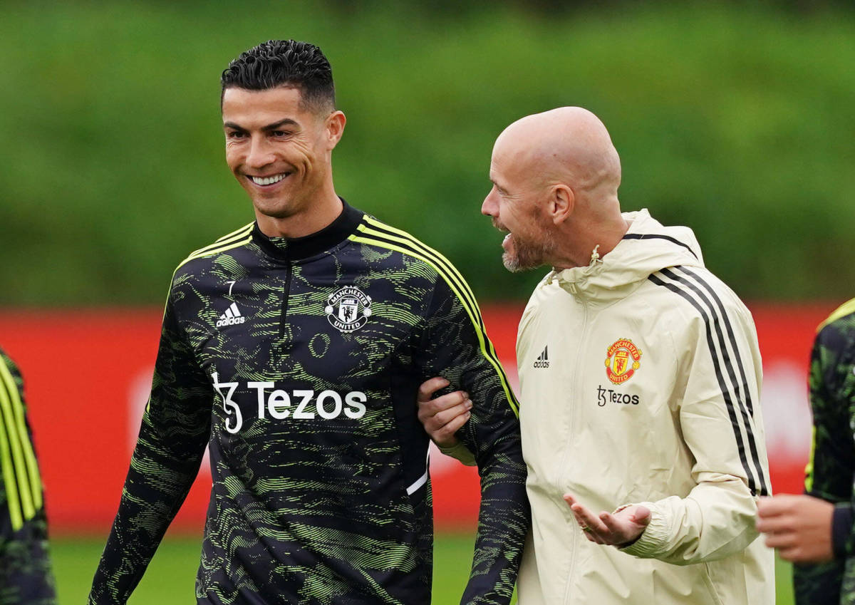 Erik ten Hag pictured (right) talking to a smiling Cristiano Ronaldo during a Manchester United training session in September 2022