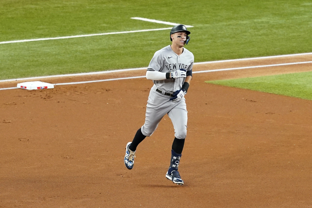 New York Yankees’ Aaron Judge rounds the bases after hitting a solo home run, his 62nd of the season, in the first inning of the second baseball game of a doubleheader against the Texas Rangers in Arlington, Texas, Tuesday, Oct. 4, 2022. With the home run, Judge set the AL record for home runs in a season, passing Roger Maris.