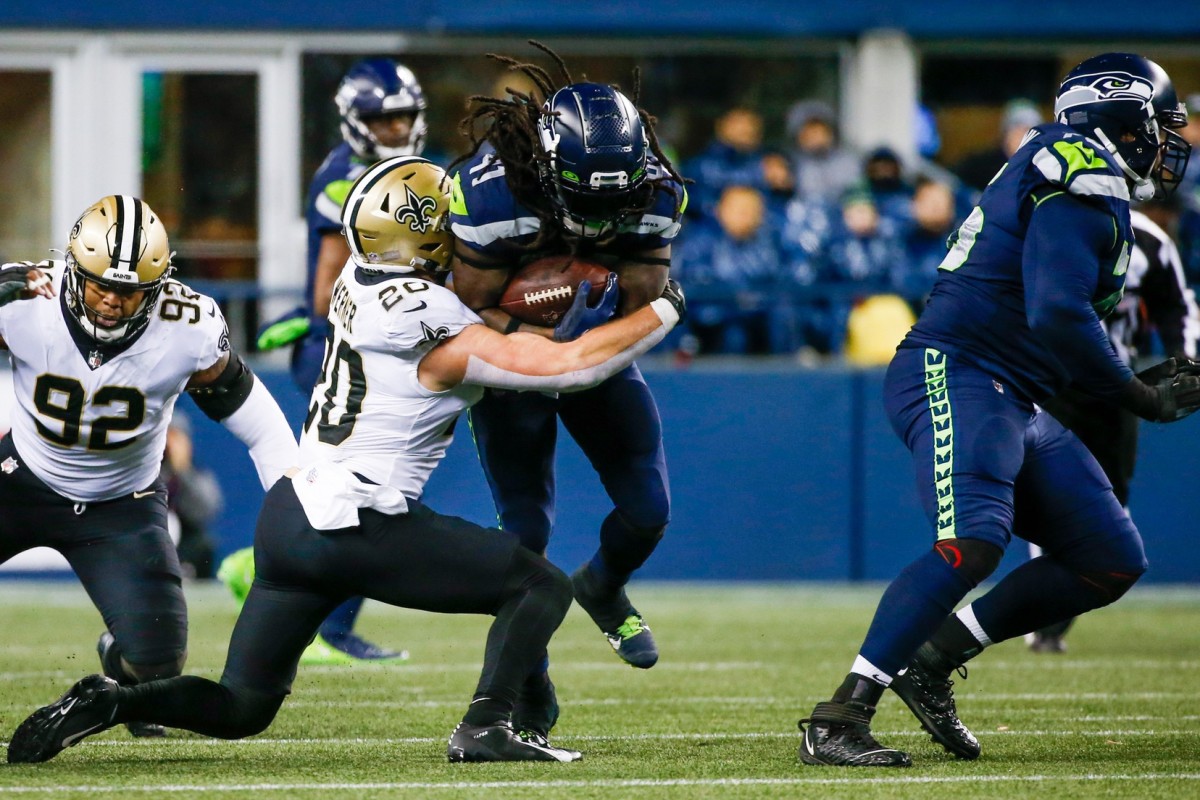 Oct 25, 2021; New Orleans Saints linebacker Pete Werner (20) tackles Seattle Seahawks running back Alex Collins (41). Mandatory Credit: Joe Nicholson-USA TODAY