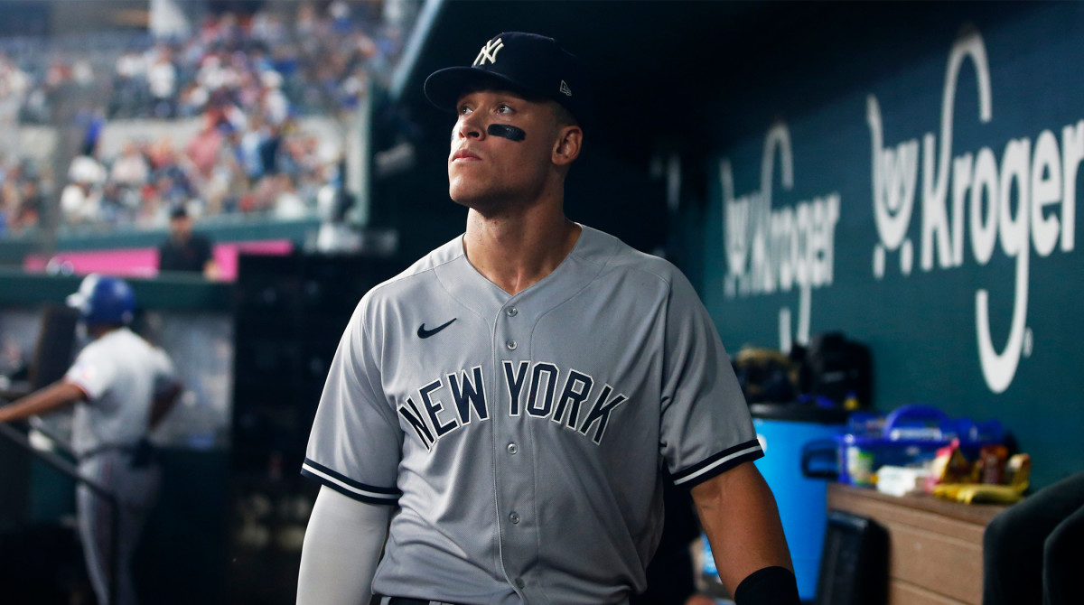 New York Yankees right fielder Aaron Judge (99) walks in the dugout at Globe Life Field.