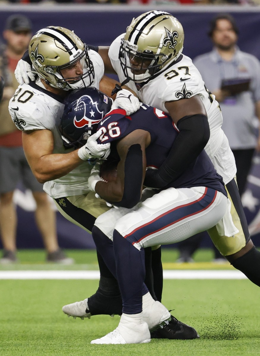 Aug 13, 2022; New Orleans Saints linebacker Chase Hansen (40) and defensive end Malcolm Roach (97) make a tackle on Houston Texans running back Royce Freeman. Mandatory Credit: Troy Taormina-USA TODAY Sports