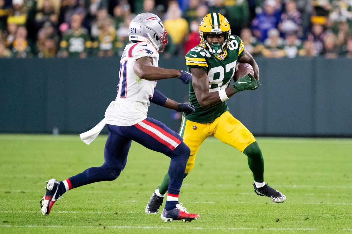 Green Bay Packers wide receiver Romeo Doubs (87) runs the ball against New England Patriots cornerback Jonathan Jones (31) in overtime on Sunday, Oct. 2, 2022, at Lambeau Field in Green Bay, Wis.