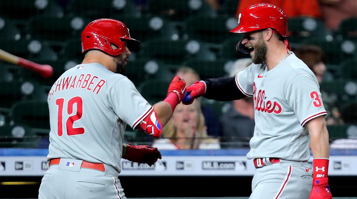 Oct 3, 2022; Houston, Texas, USA; Philadelphia Phillies left fielder Kyle Schwarber (12) celebrates with designated hitter Bryce Harper (3) after hitting a home run against the Houston Astros during the first inning at Minute Maid Park.