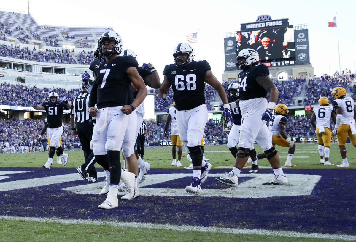 Oct 7, 2017; Fort Worth, TX, USA; TCU Horned Frogs quarterback Kenny Hill (7) celebrates with teammates after scoring the game-winning touchdown during the fourth quarter against the West Virginia Mountaineers at Amon G. Carter Stadium.