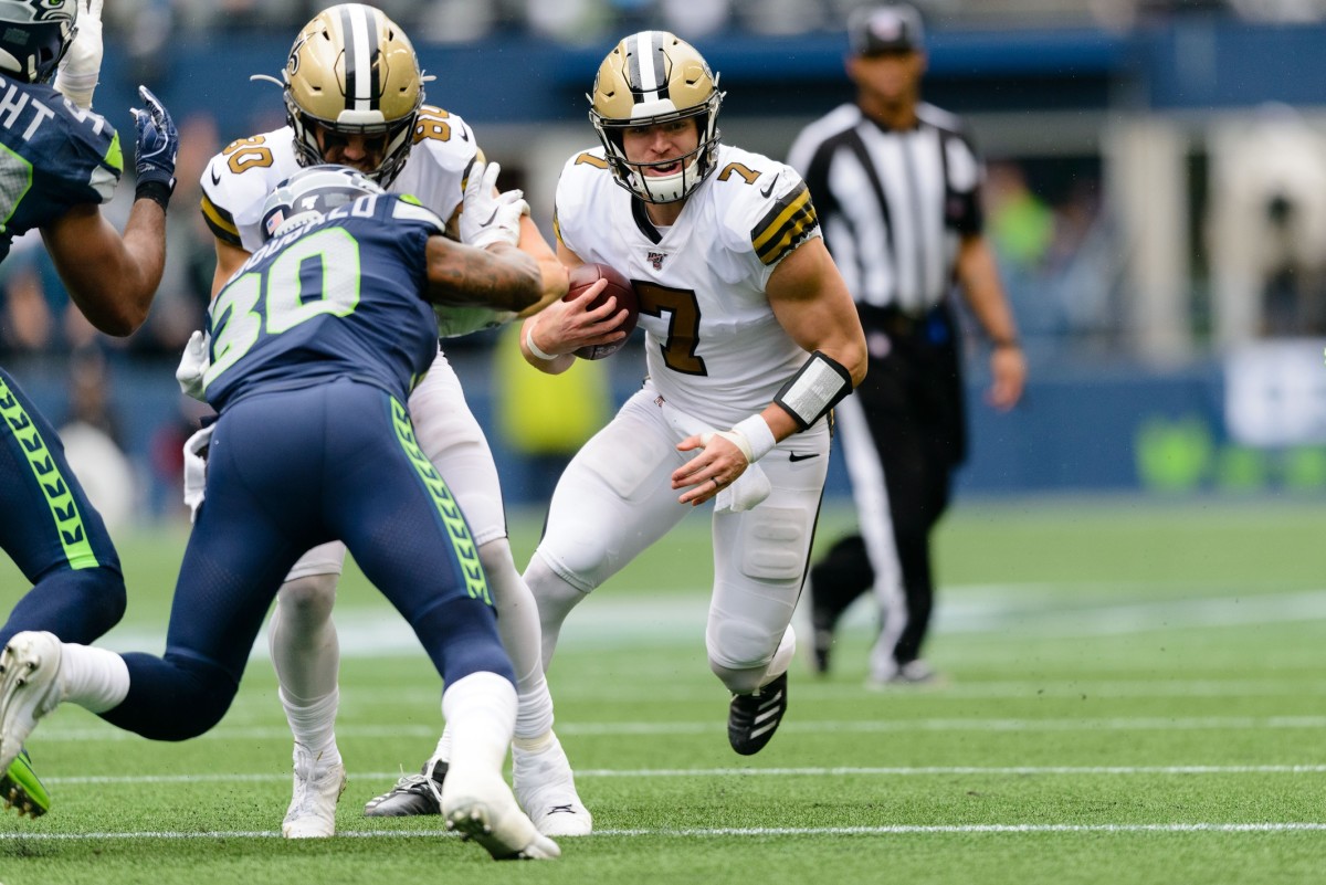 New Orleans Saints Taysom Hill (7) carries the ball against the Seattle Seahawks. Mandatory Credit: Steven Bisig-USA TODAY Sports