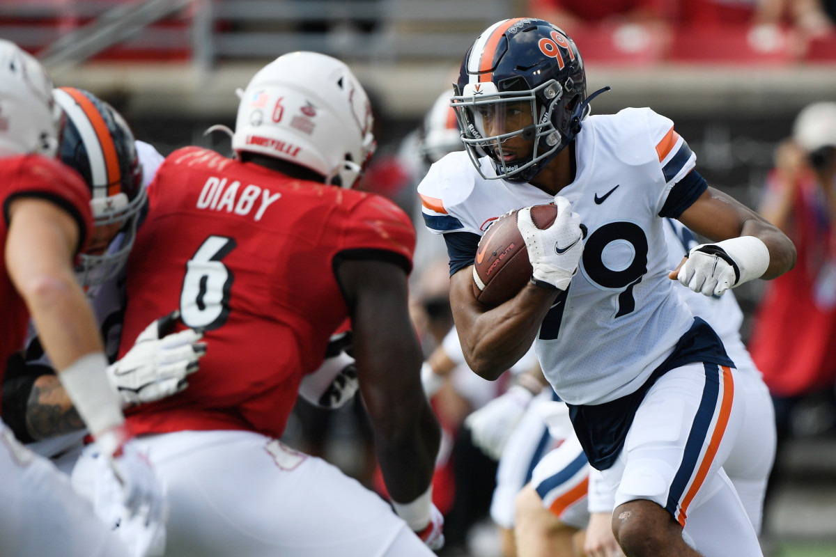 Virginia Cavaliers wide receiver Keytaon Thompson (99) runs the ball against the Louisville Cardinals during the first half at Cardinal Stadium. Virginia defeated Louisville 34-33.