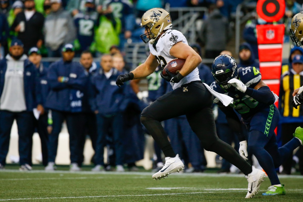 Oct 25, 2021; New Orleans Saints tight end Adam Trautman (82) runs for yards after the catch as Seattle Seahawks linebacker Jordyn Brooks (56) trails in pursuit. Mandatory Credit: Joe Nicholson-USA TODAY Sports