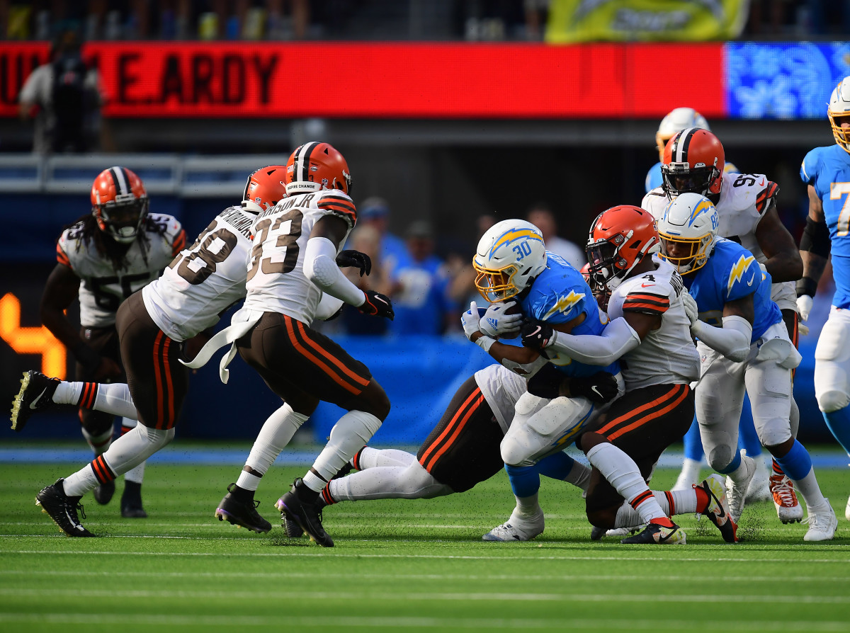 Oct 10, 2021; Inglewood, California, USA; Los Angeles Chargers running back Austin Ekeler (30) is brought down by Cleveland Browns middle linebacker Anthony Walker (4) during the second half at SoFi Stadium. Mandatory Credit: Gary A. Vasquez-USA TODAY Sports