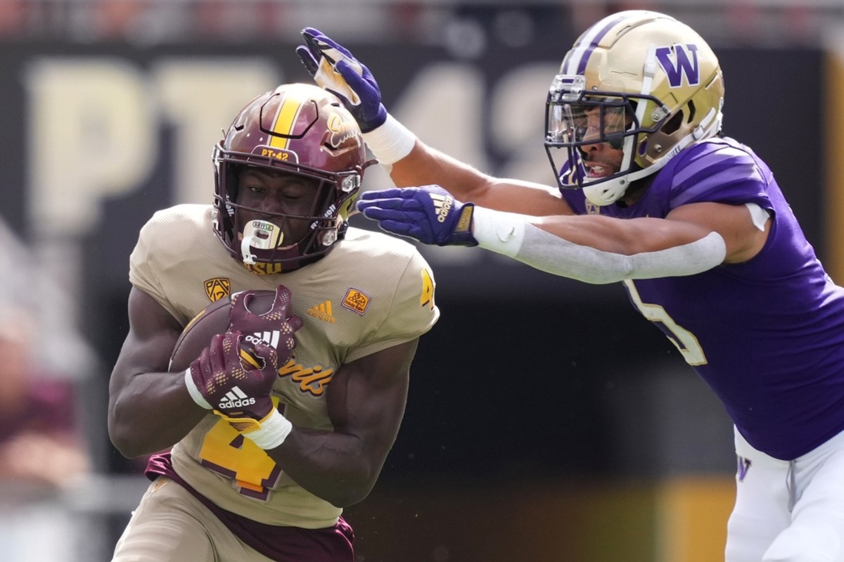 UW safety Alex Cook tries to pull down Sun Devils running back Daniyel Ngata.