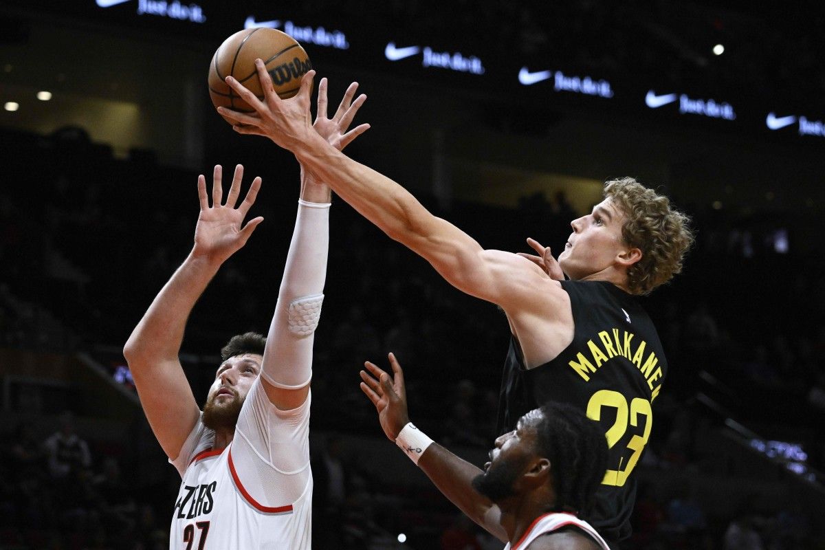 Utah Jazz forward Lauri Markkanen (23) reaches for a rebound during the first half against Portland Trail Blazers center Jusuf Nurkic (27) at Moda Center.