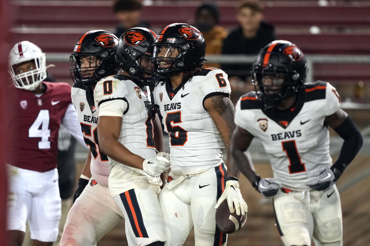 Stanford, California, USA; Oregon State Beavers running back Damien Martinez (6) celebrates with wide receiver Tre'Shaun Harrison (0) after scoring a touchdown against the Stanford Cardinal during the fourth quarter at Stanford Stadium.