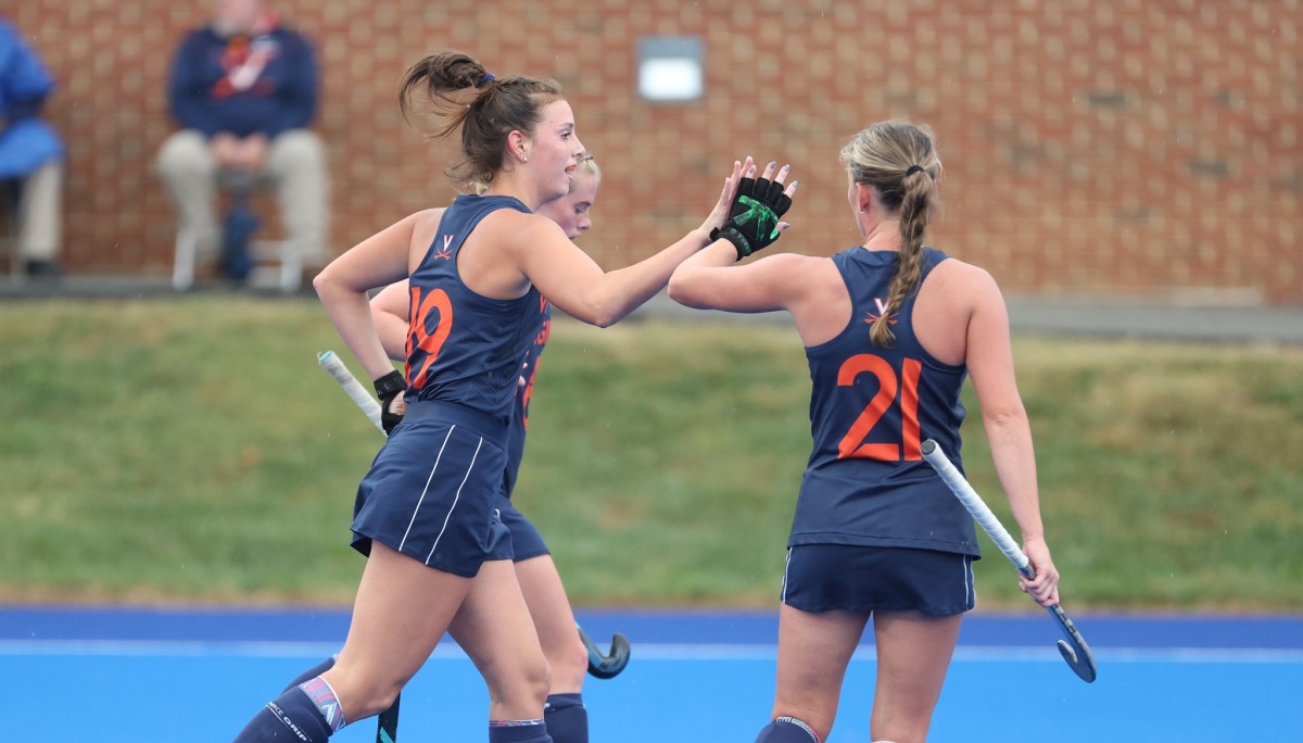 Dani Mendez-Trendler celebrates with her teammates after scoring a goal for the Virginia Cavaliers field hockey team.