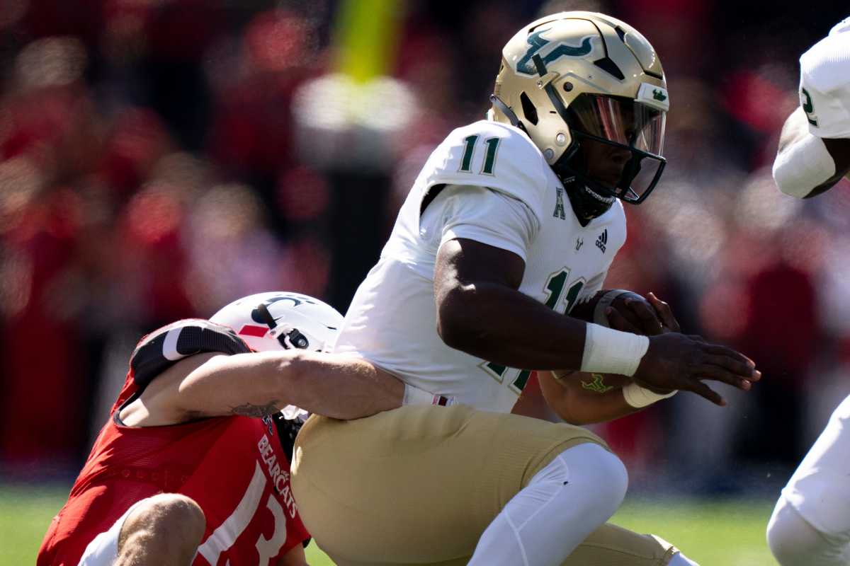 Cincinnati Bearcats linebacker Ty Van Fossen (13) tackles South Florida Bulls quarterback Gerry Bohanon (11) in the first quarter of the NCAA Football game between the Cincinnati Bearcats and the South Florida Bulls at Nippert Stadium in Cincinnati on Saturday, Oct. 8, 2022. South Florida Bulls At Cincinnati Bearcats 171