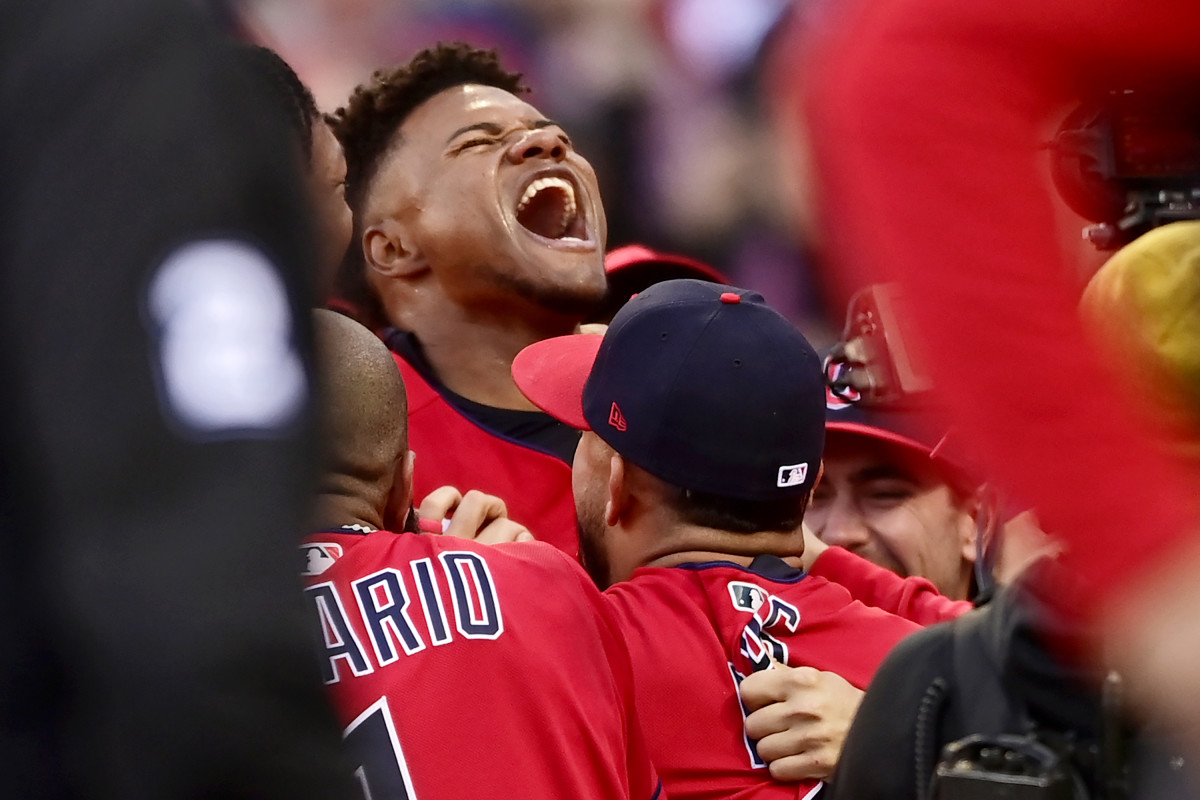 Óscar González celebrates with his teammates after his 15th inning walk-off home run clinched the AL Wild-Card Series for the Guardians.