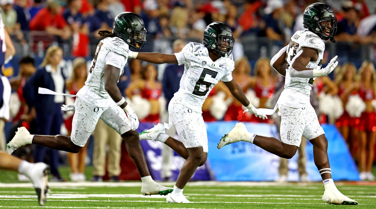 The Oregon secondary celebrates a turnover against the Arizona Wildcats.
