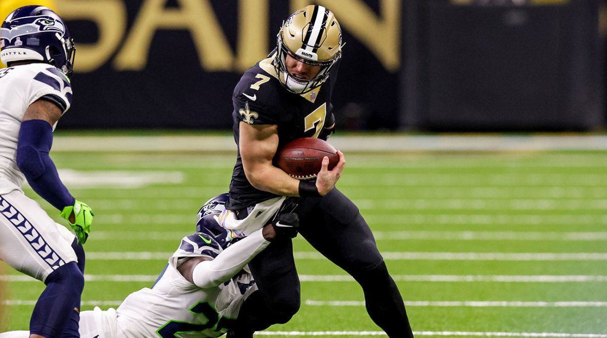 Taysom Hill runs through a Seahawks defender during a huge Week 5