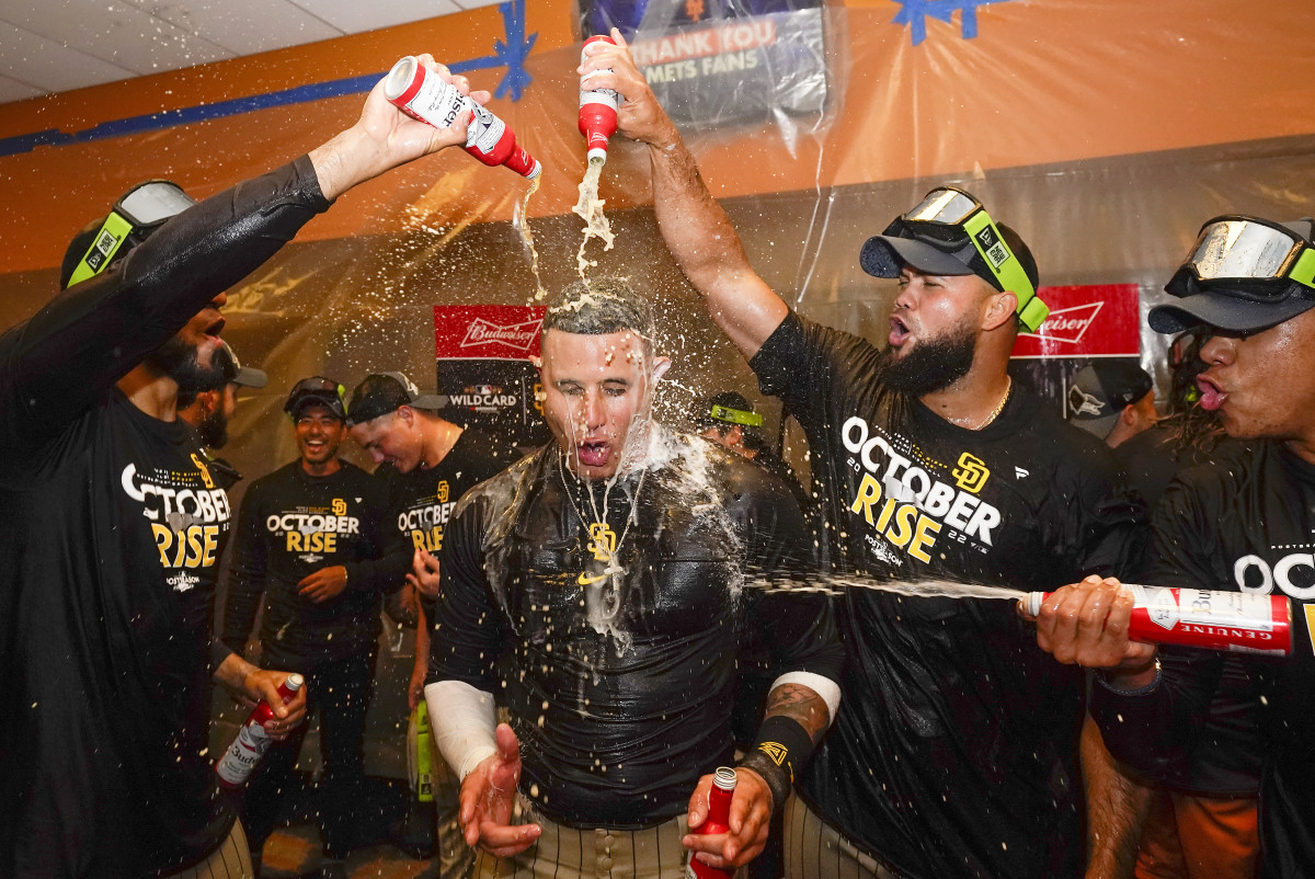 The Padres celebrate in the locker room after defeating the Mets in the NL wild-card series.