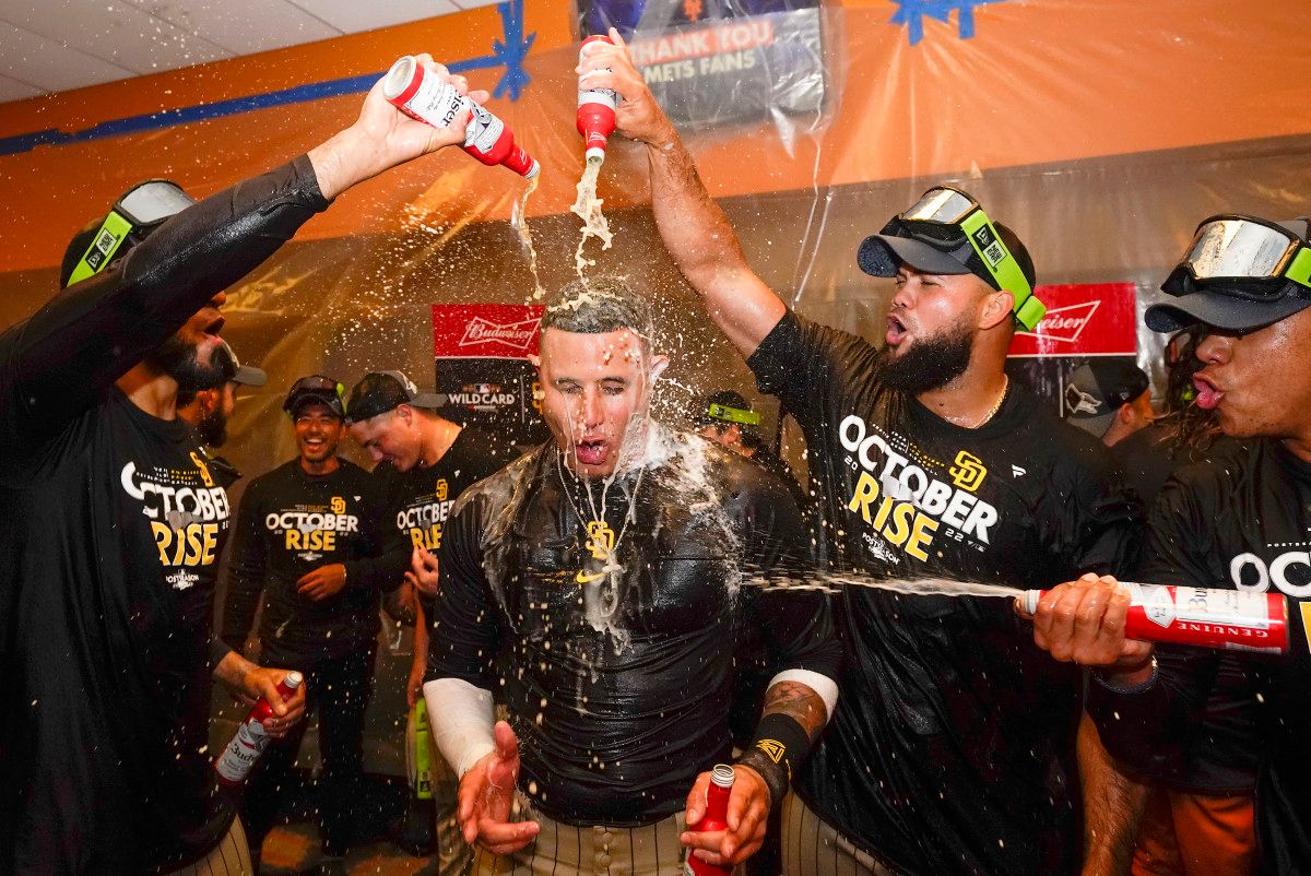 The Padres celebrate in the locker room after defeating the Mets in the NL wild-card series.