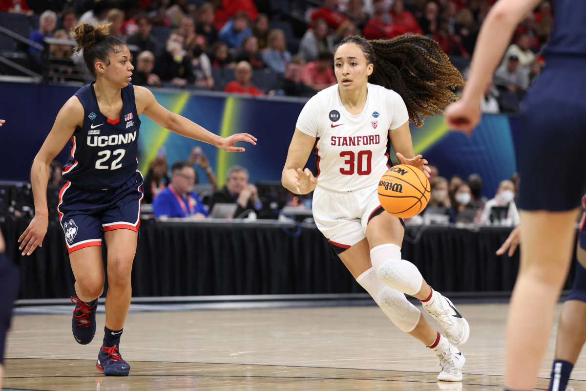 Stanford Cardinal guard Haley Jones (30) dribbles the ball as UConn Huskies guard Evina Westbrook (22) defends during the first half in the Final Four semifinals of the women's college basketball NCAA Tournament at Target Center.