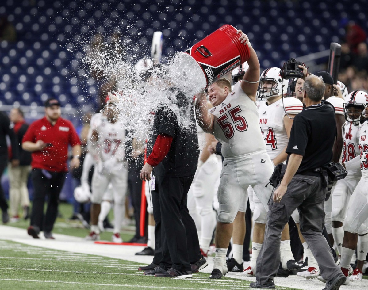 Northern Illinois Huskies defensive tackle Weston Kramer (55) dumps water on head coach Rod Carey during the second half against the Buffalo Bulls at Ford Field.