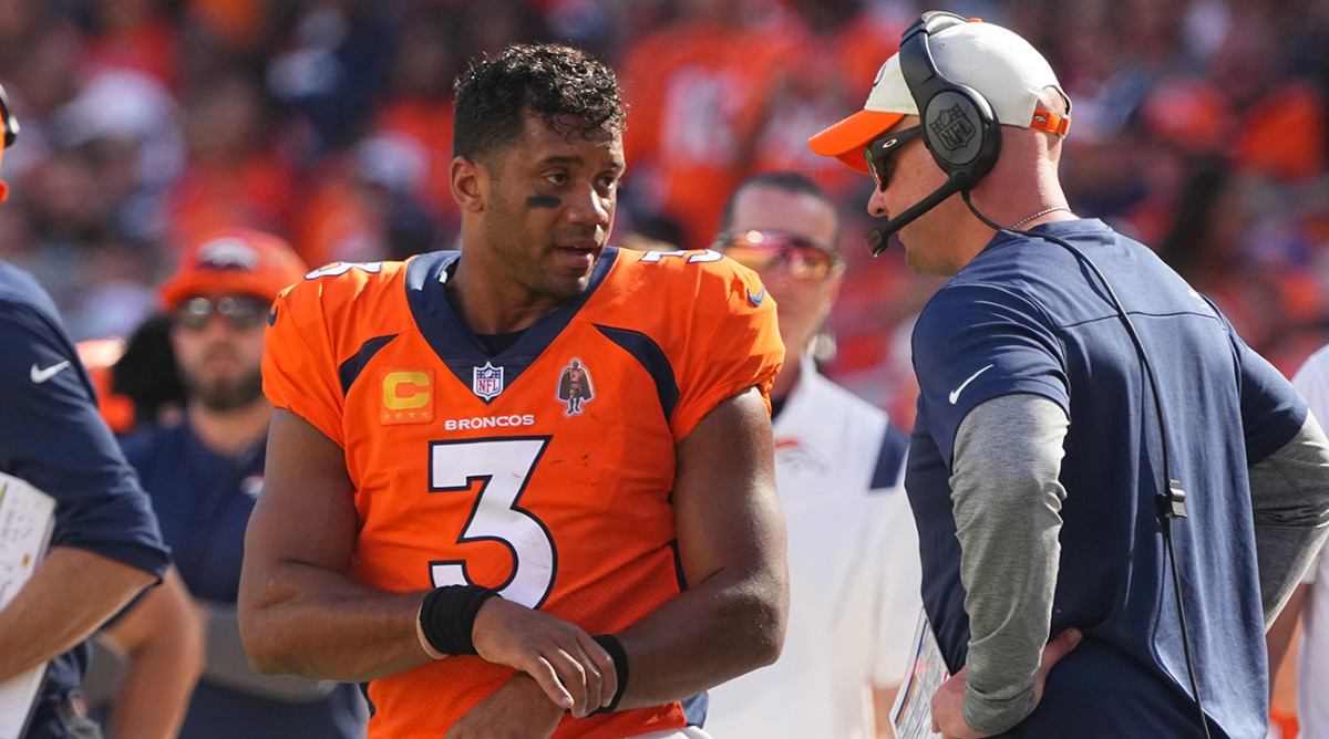 Broncos quarterback Russell Wilson talkking to coach Nathaniel Hackett.