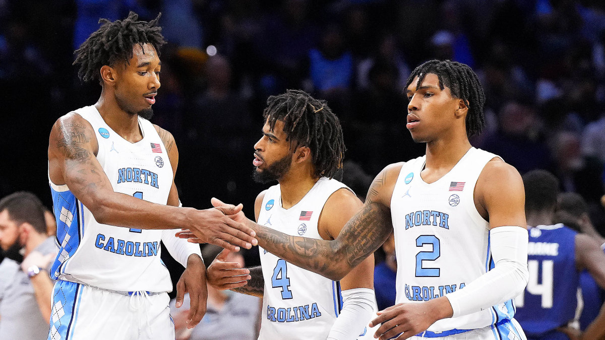 UNC’s Leaky Black and Caleb Love slap hands