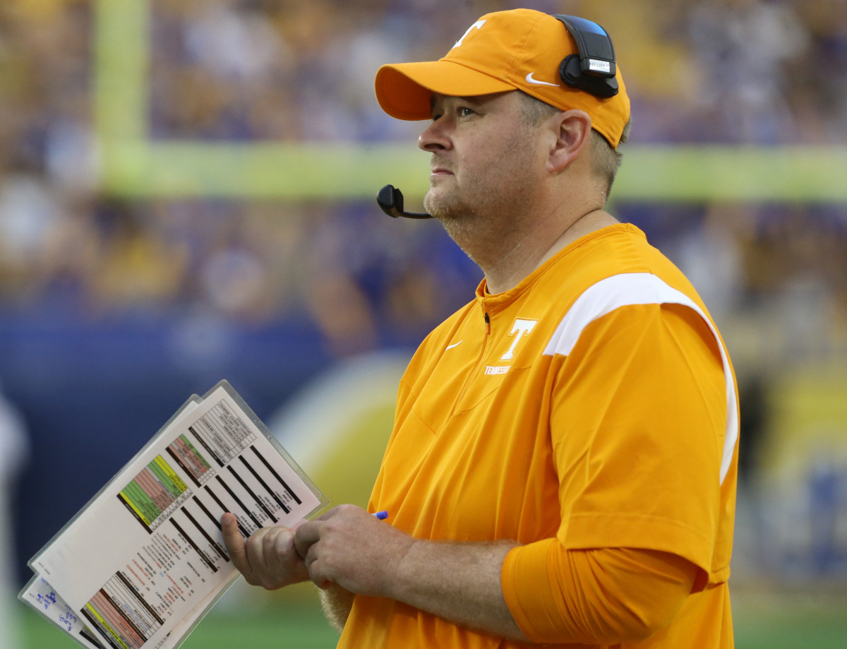 Tennessee coach Josh Heupel calls in a play from the sidelines.