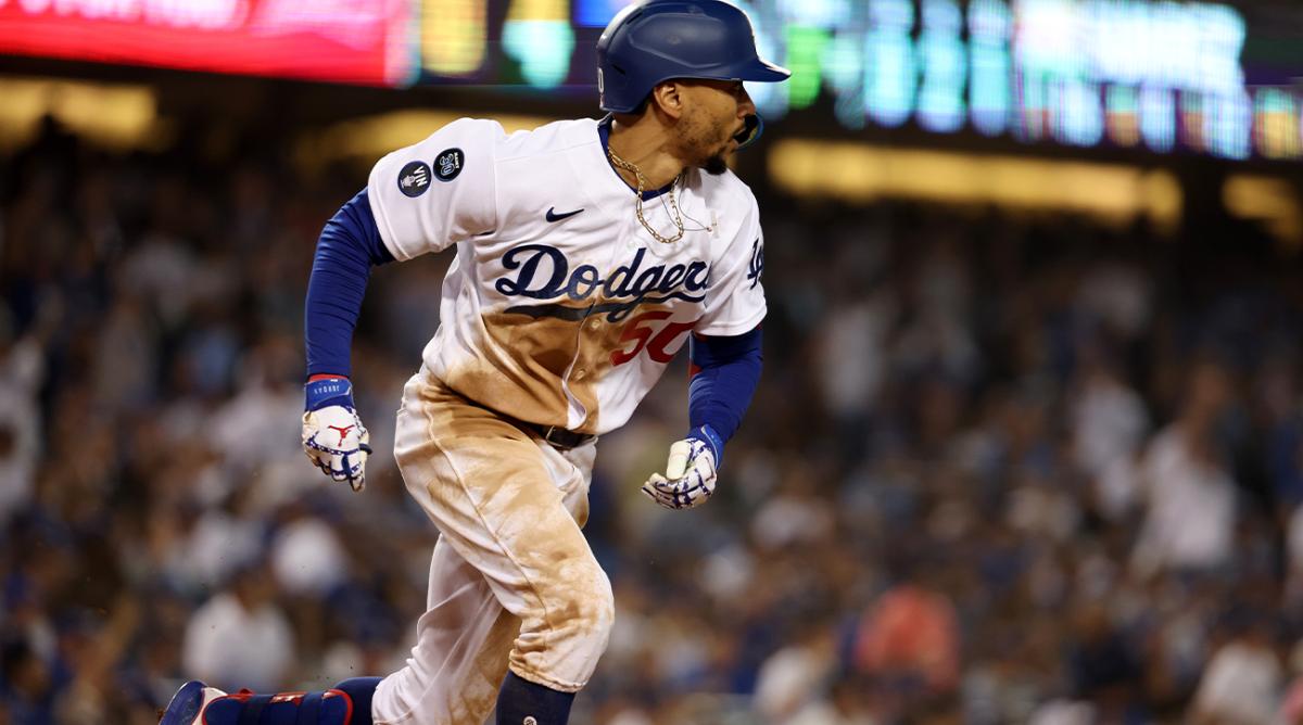 Oct 12, 2022; Los Angeles, California, USA; Los Angeles Dodgers right fielder Mookie Betts (50) hits a double in the seventh inning of game two of the NLDS for the 2022 MLB Playoffs against the San Diego Padres at Dodger Stadium.