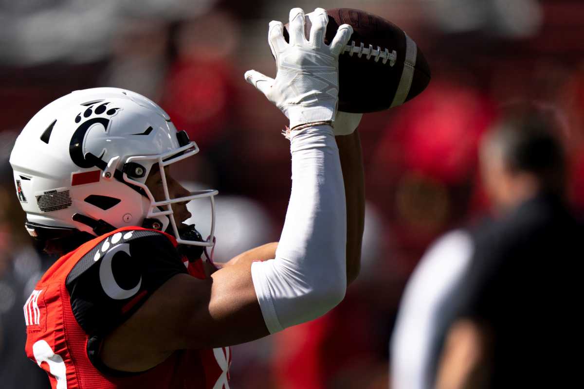 Cincinnati Bearcats wide receiver Blue Smith (83) catches a pass while warming up before the NCAA Football game between the Cincinnati Bearcats and the South Florida Bulls at Nippert Stadium in Cincinnati on Saturday, Oct. 8, 2022. South Florida Bulls At Cincinnati Bearcats 0023