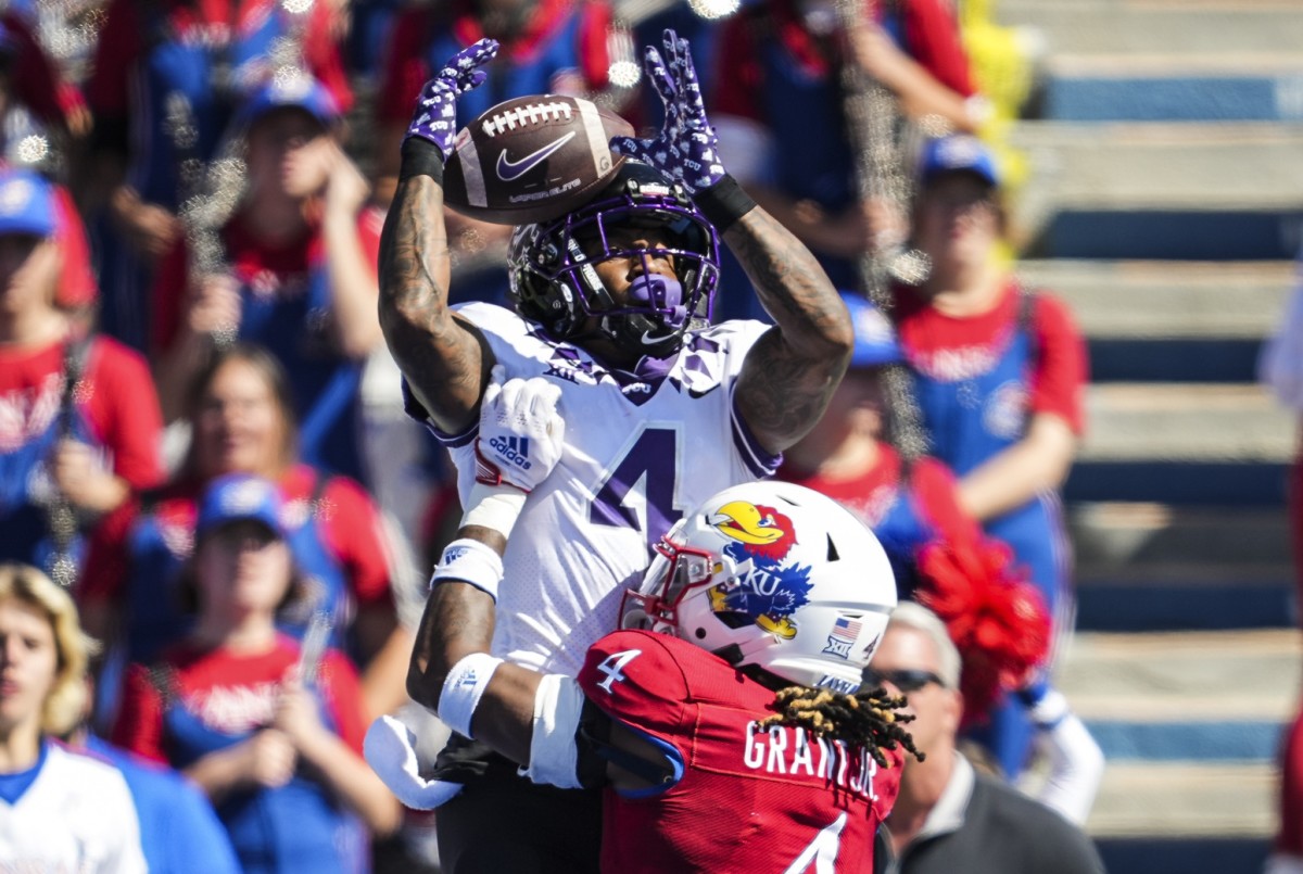 Oct 8, 2022; Lawrence, Kansas, USA; TCU Horned Frogs wide receiver Taye Barber (4) catches a touchdown pass over Kansas Jayhawks safety Marvin Grant (4) during the second half at David Booth Kansas Memorial Stadium.