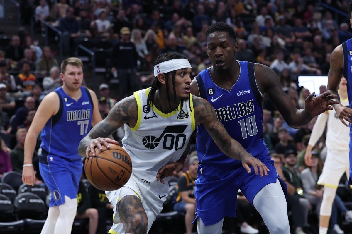 Utah Jazz guard Jordan Clarkson (00) dribbles the ball against Dallas Mavericks forward Dorian Finney-Smith (10) in the third quarter at Vivint Arena.