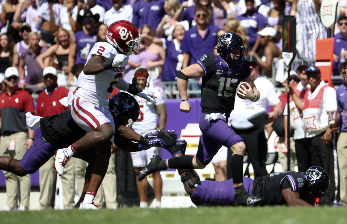 TCU Horned Frogs quarterback Max Duggan (15) runs with the ball as Oklahoma Sooners linebacker David Ugwoegbu (2) chases during the second half at Amon G. Carter Stadium.