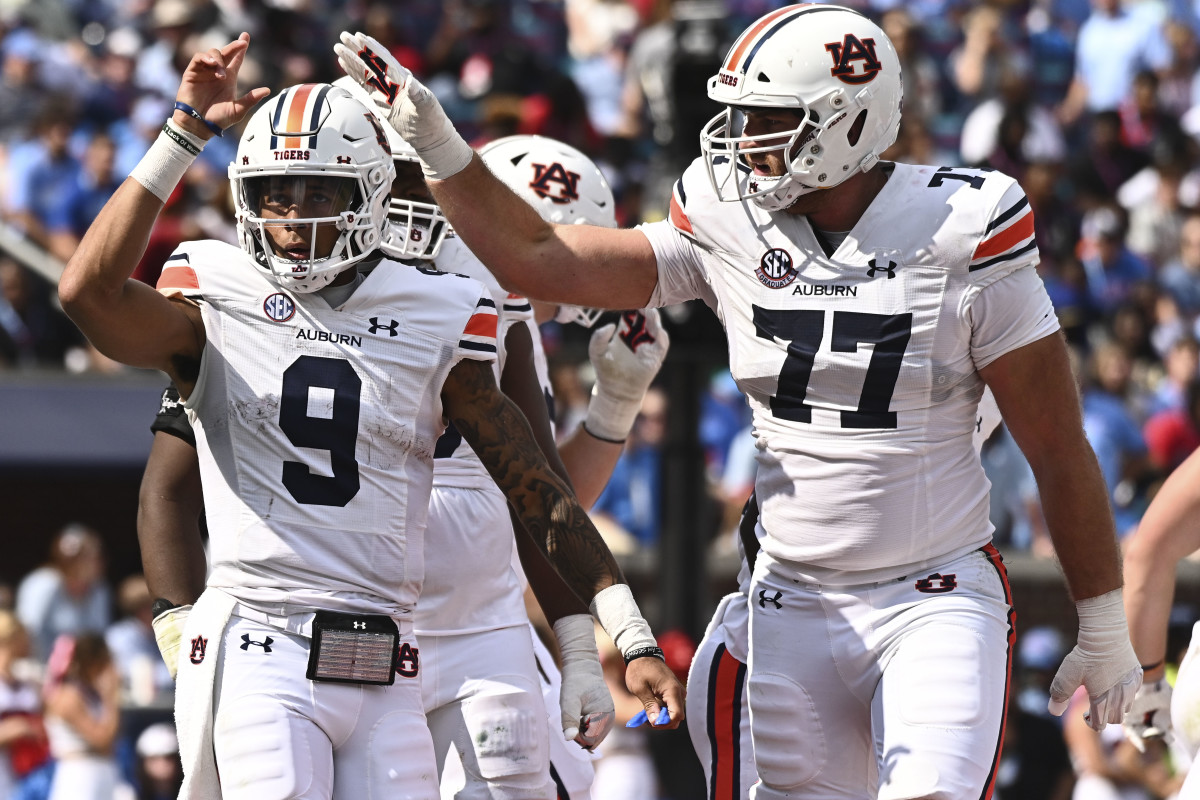 Oct 15, 2022; Oxford, Mississippi, USA; Auburn Tigers quarterback Robby Ashford (9) reacts with offensive lineman Kilian Zierer (77) after a touchdown during the third quarter at Vaught-Hemingway Stadium. Mandatory Credit: Matt Bush-USA TODAY Sports
