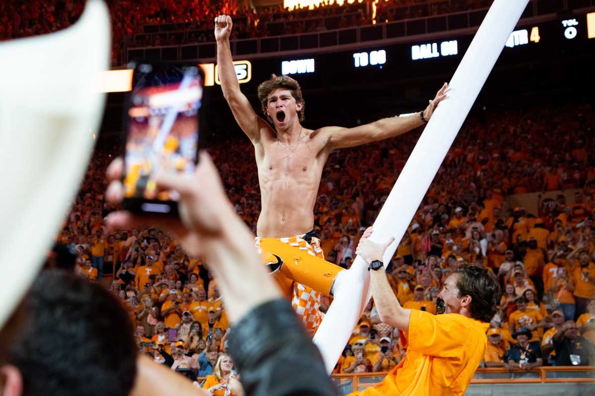 A fan cheer after climbing the downed goal past after Tennessee's game against Alabama in Neyland Stadium in Knoxville, Tenn., on Saturday, Oct. 15, 2022.