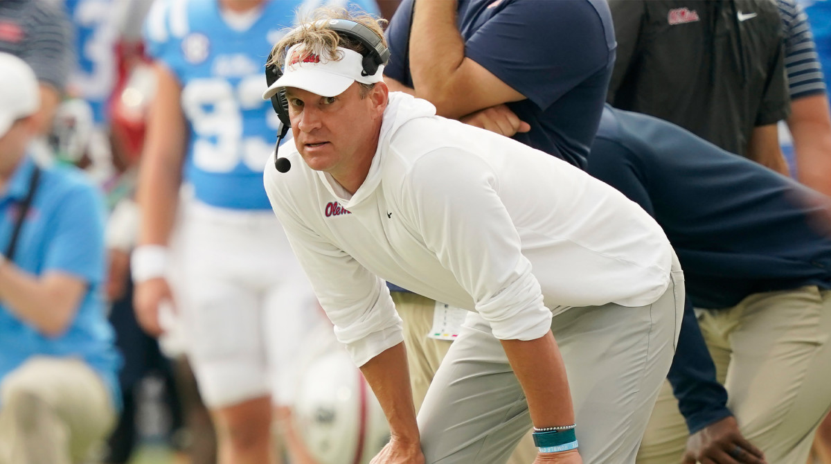 Lane Kiffin bends over on the sideline