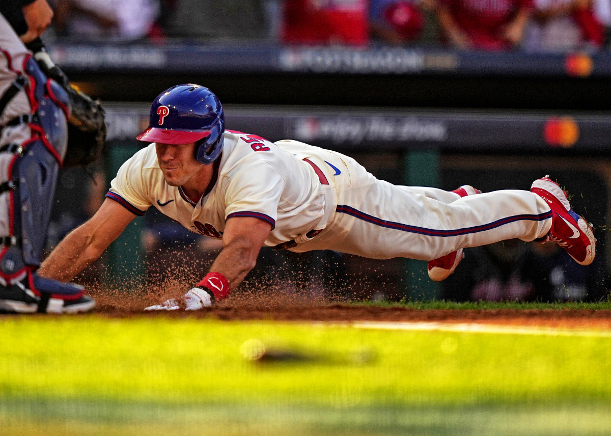 Phillies catcher J.T. Realmuto slides across home plate to score on his inside-the-park home run in Game 4 of the NLDS against the Braves.
