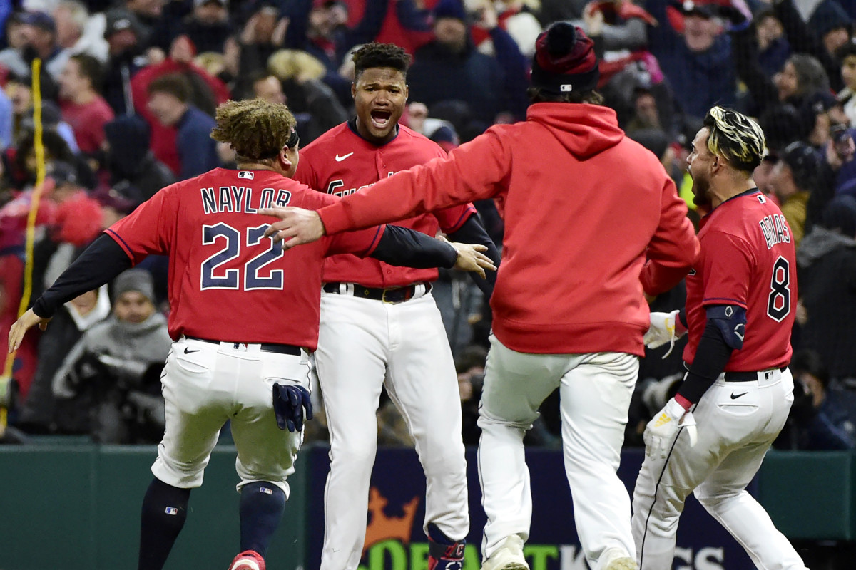 Oscar González celebrates with his teammates after walking off the Yankees.