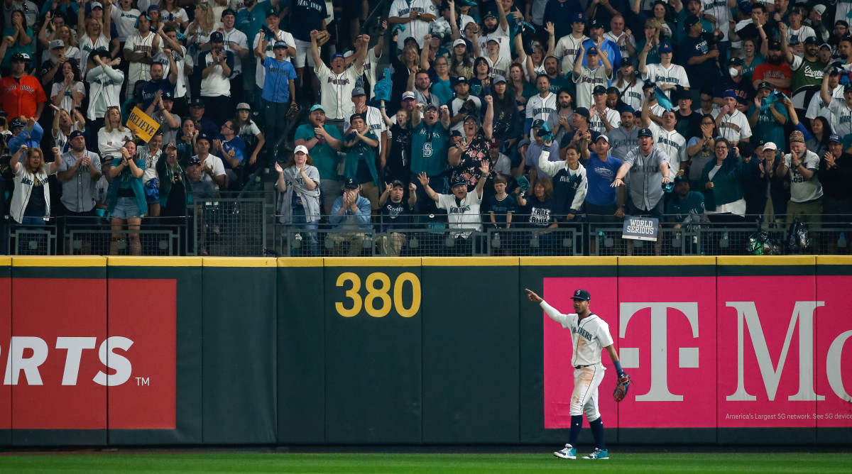 Mariners outfielder Julio Rodriguez gestures to fans at T-Mobile Park in Seattle during Game 3 of the ALDS.