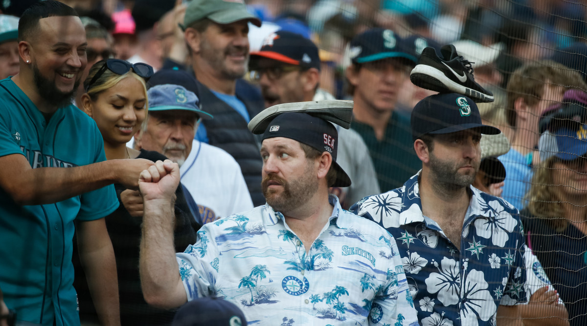 Mariners fans fist bump during Game 3 of the 2022 ALDS