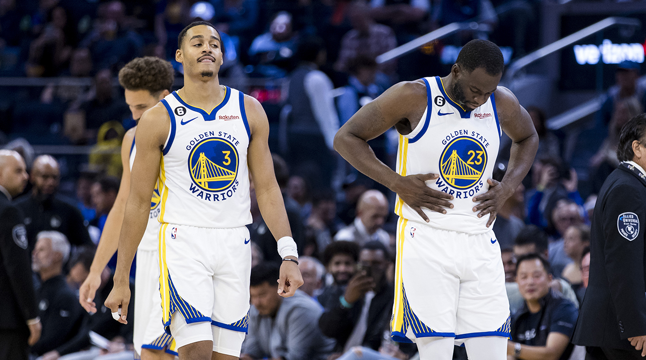 Warriors guard Jordan Poole (3) and forward Draymond Green (23) re-enter the court after a time-out during the first half of the game against the Nuggets at Chase Center.