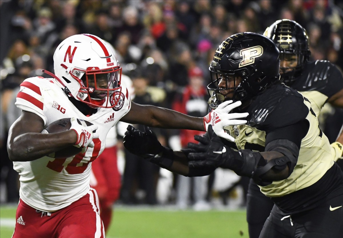 Oct 15, 2022; West Lafayette, Indiana, USA; Nebraska Cornhuskers running back Anthony Grant (10) runs past Purdue Boilermakers defensive tackle Branson Deen (58) during the second half at Ross-Ade Stadium.