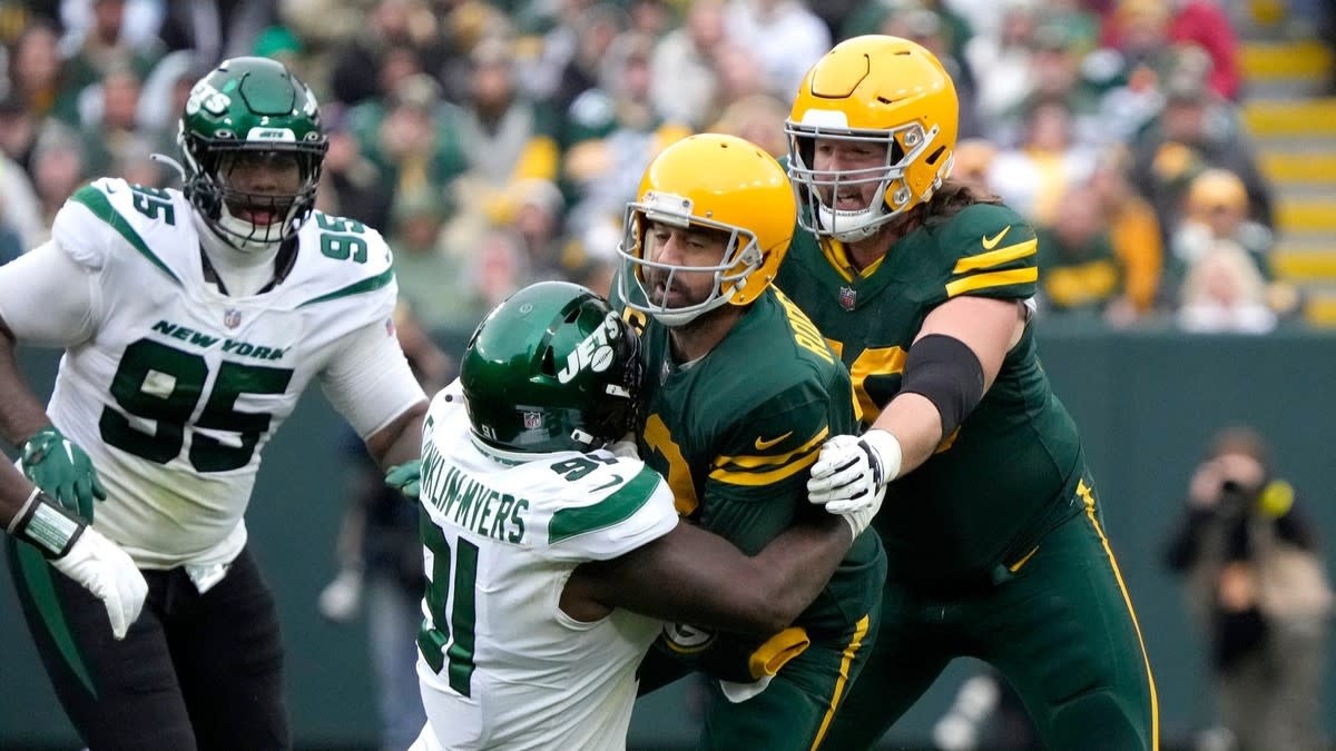 Aaron Rodgers is sacked by John Franklin-Myers, who beat Royce Newman. (Photo by USA Today Sports Images)