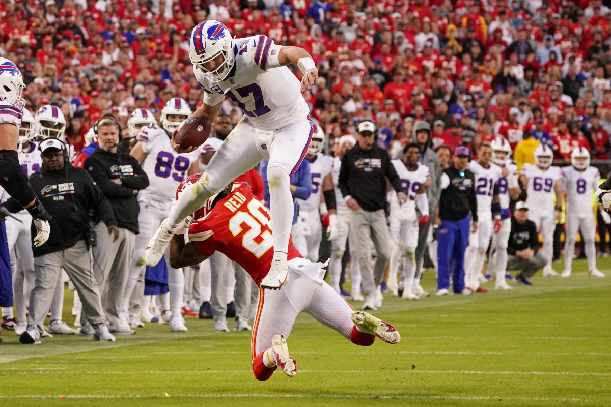 Josh Allen lands after hurdling Justin Reid