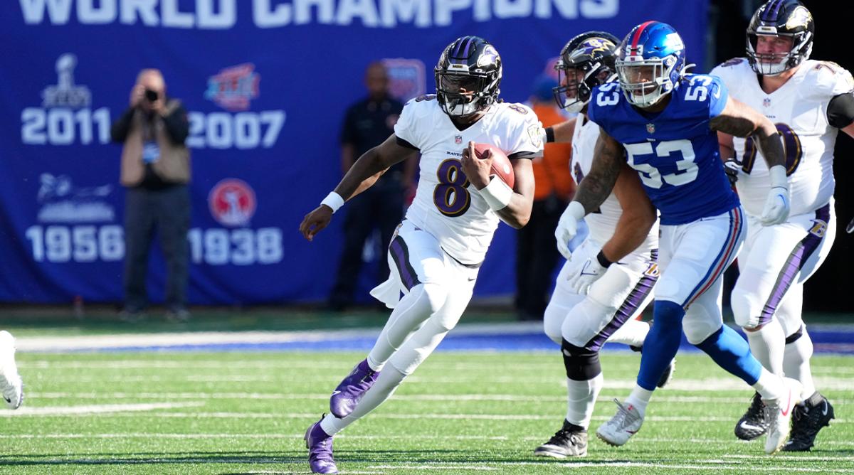 Oct 16, 2022; East Rutherford, New Jersey, USA; Baltimore Ravens quarterback Lamar Jackson (8) runs with the ball against New York Giants linebacker Oshane Ximines (53) during the second half at MetLife Stadium.