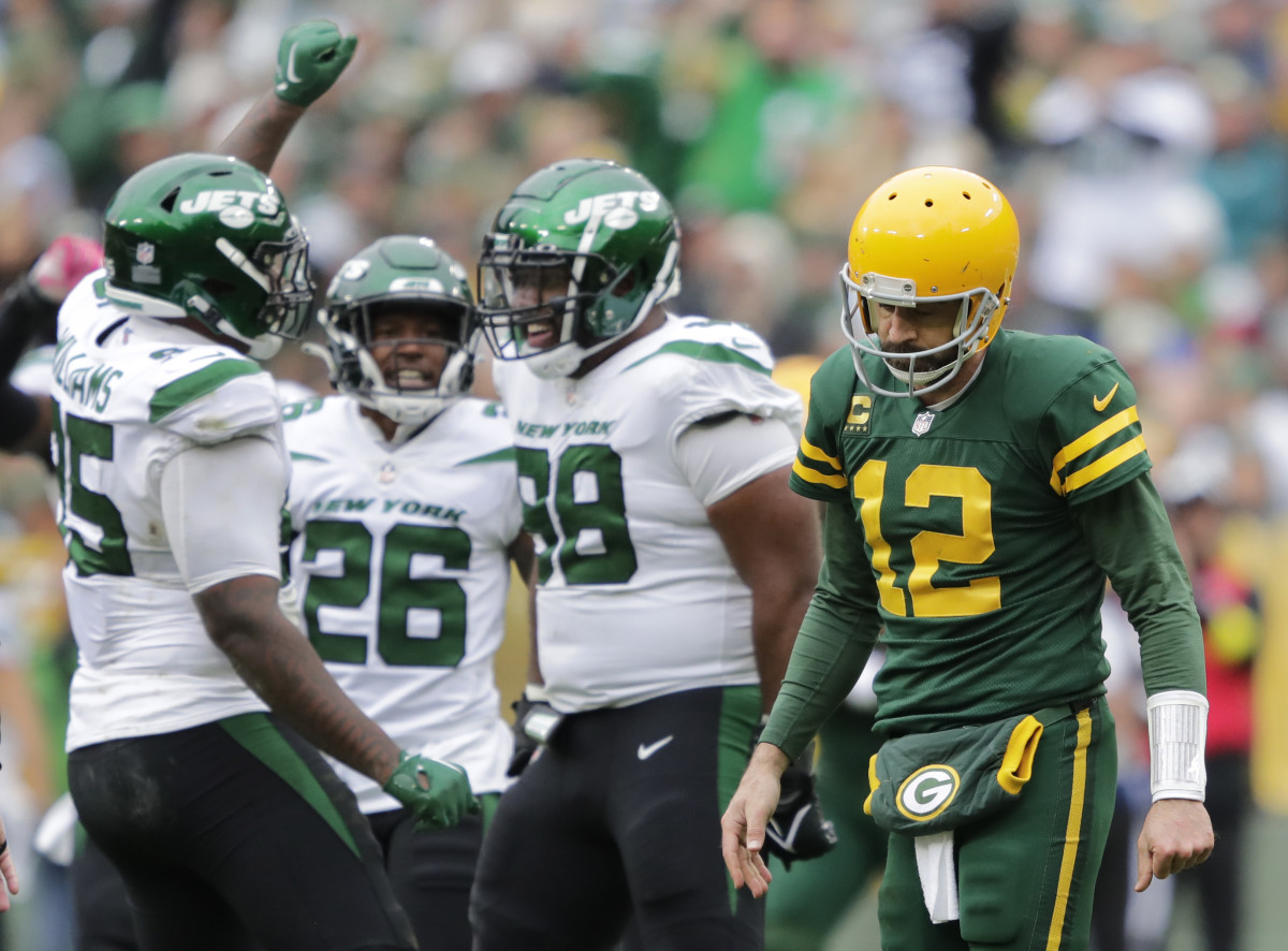 Green Bay Packers quarterback Aaron Rodgers (12) walks off the field after getting sacked by New York Jets defensive tackle Quinnen Williams (95) in the third quarter at Lambeau Field.