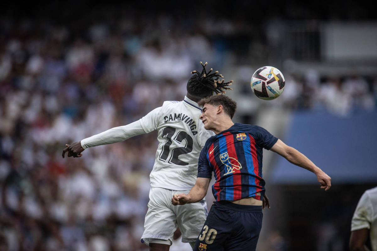 Barcelona midfielder Gavi pictured (right) jumping for a header against Real Madrid's Eduardo Camavinga in October 2022