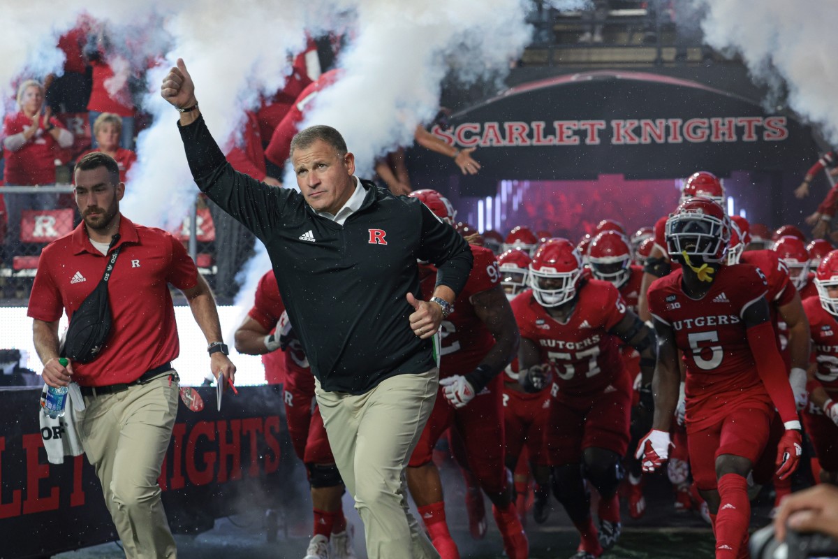 Rutgers Scarlet Knights head coach Greg Schiano leads the Scarlet Knights football team onto the field before a game against the Iowa Hawkeyes at SHI Stadium.