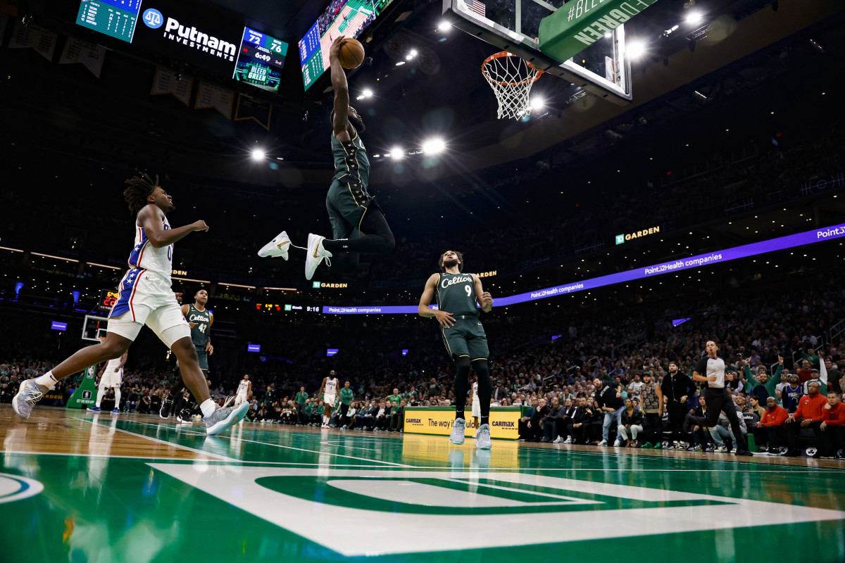 Boston Celtics guard Jaylen Brown (7) goes in for a dunk past Philadelphia 76ers guard Tyrese Maxey (0) during the third quarter at TD Garden.