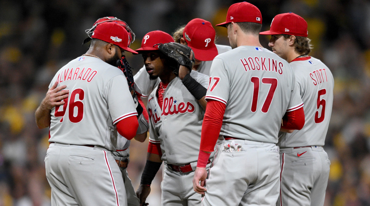 Phillies players gather at the mound in the ninth inning of Game 1 of the 2022 NLCS.