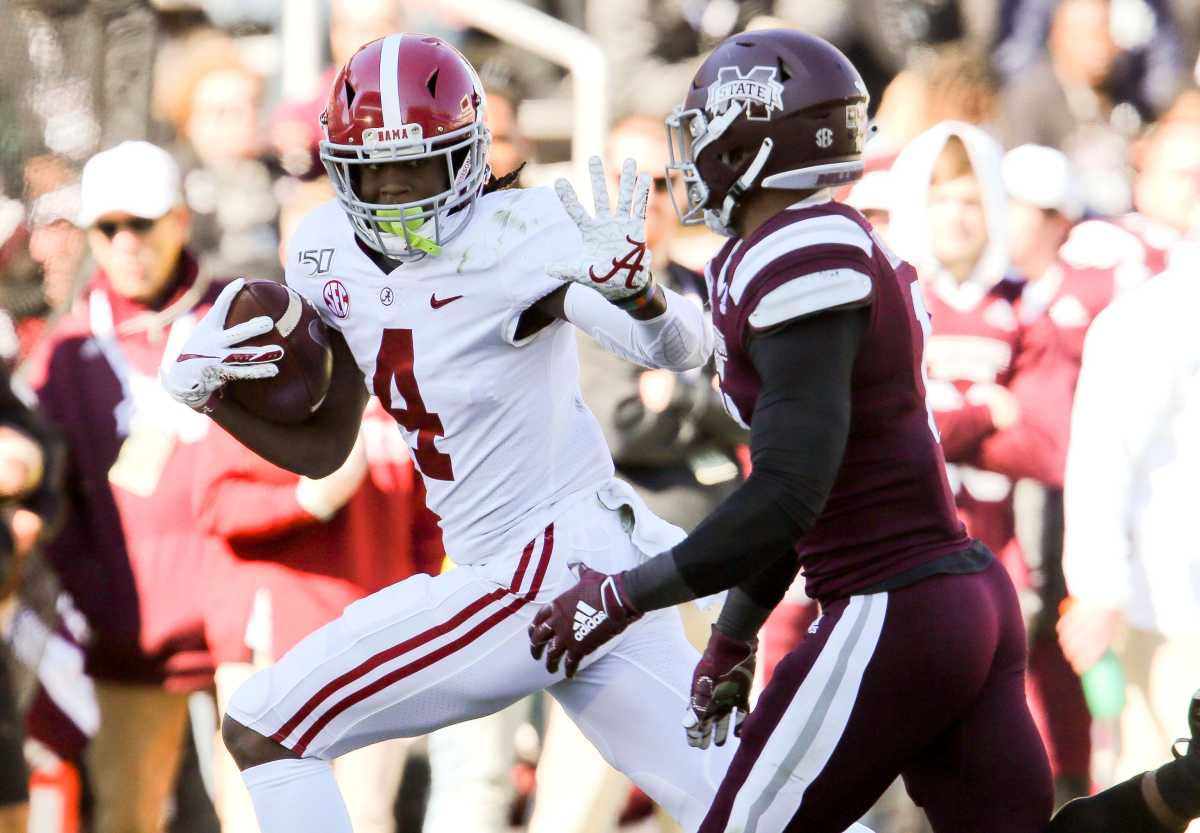 Alabama wide receiver Jerry Jeudy (4) stiff arms a defender but was called for an offensive face mask penalty, negating a touchdown against Mississippi State Saturday, Nov. 16, 2019 in Starkville